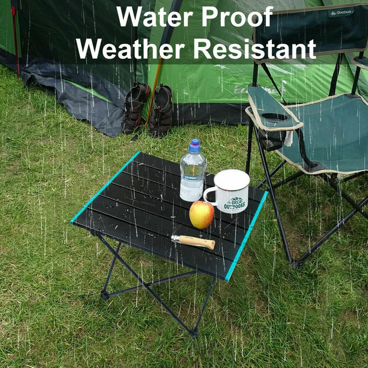 Portable aluminum camping table collapsed and folded for easy transport, demonstrating its compact design.