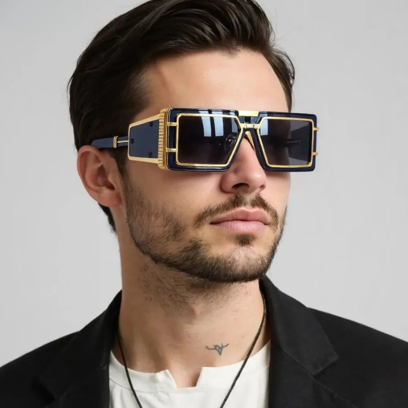 Unisex oversized geometric sunglasses with gold details. High-fashion eyewear offering UV protection.