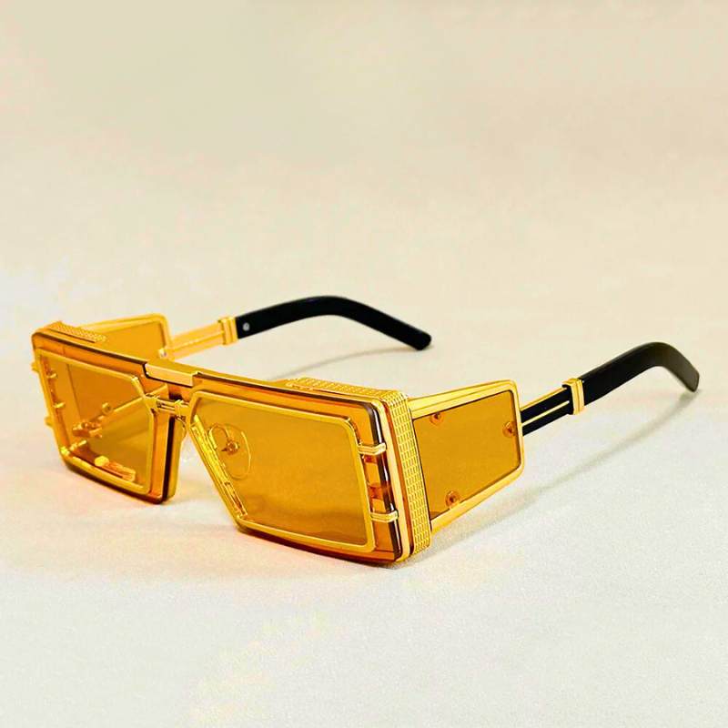 Statement geometric eyewear for unisex fashion. Oversized shades with elegant gold details and UV protection.