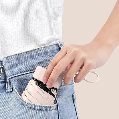 Mini compact travel umbrella, easily fits in a pocket or bag for ultimate portability.