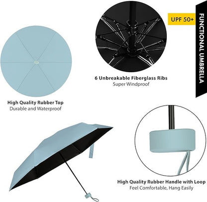Unisex compact travel umbrella held in hand, showcasing its small, portable size.