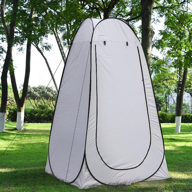 Outdoor shower tent, set against a backdrop of mountains, emphasizing portability for adventures