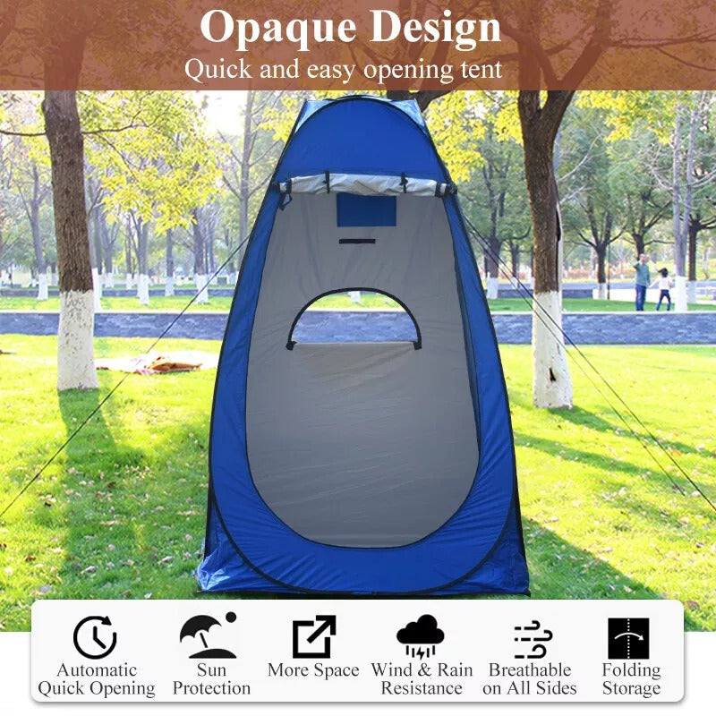 Outdoor gear pop-up shower tent, used as a changing room by a lake, serene environment