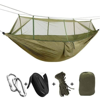 Empty portable camping hammock with mosquito net, inviting for a relaxing outdoor experience.