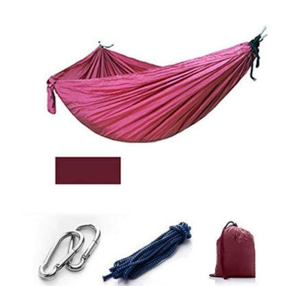 Camping hammock with mosquito net laid flat, showcasing its full size and bug-proof design.