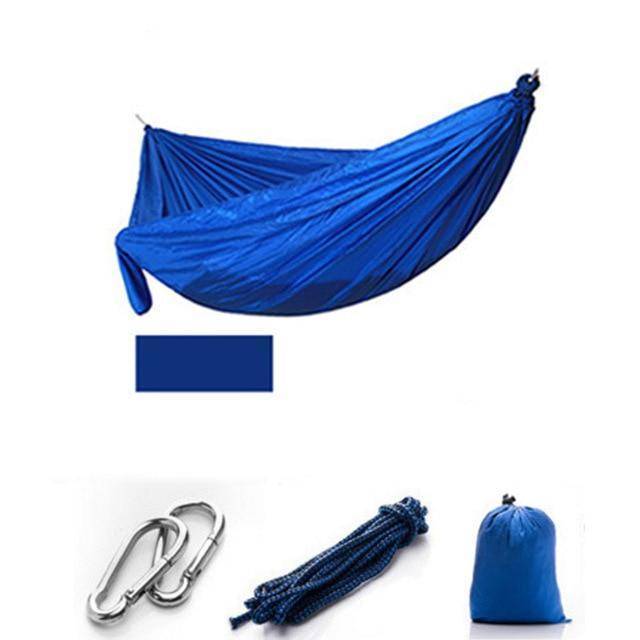 Hiking gear essential: a camping hammock with mosquito netting, packed for an outdoor adventure.