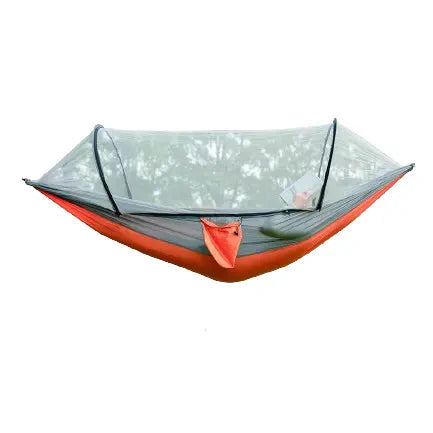 Outdoor camping hammock with mosquito net and tree straps, ready for adventure.