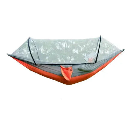 Outdoor camping hammock with mosquito net and tree straps, ready for adventure.