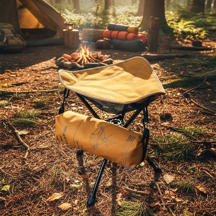 Portable camping stool demonstrating its compact folded size for easy carrying