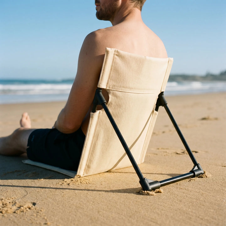 Unisex portable folding floor chair for outdoor comfort, ideal for camping, beach, or picnics.
