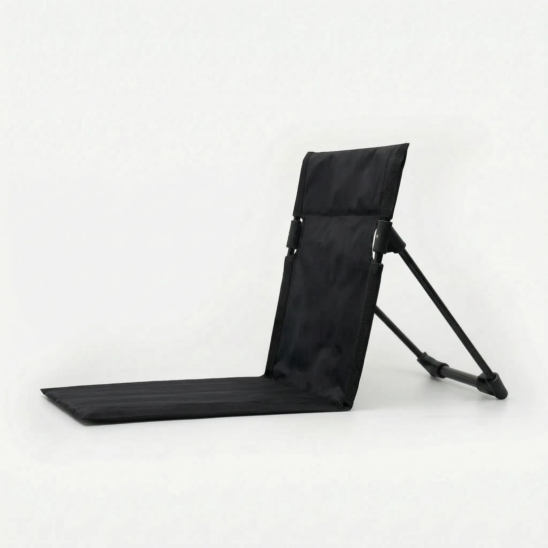 Folding floor chair for adults, unisex design, provides comfortable back support for ground-level outdoor seating.