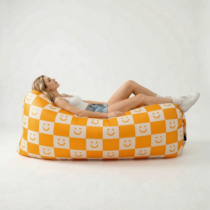 Compact, deflated portable air lounger next to an inflated one, showing ease of transport for outdoor seating.