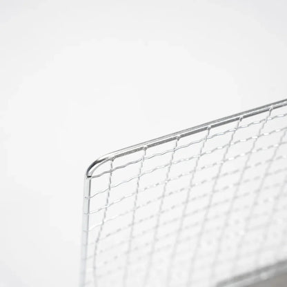 Detail of the locking mechanism on the folding portable stainless steel camping grill.