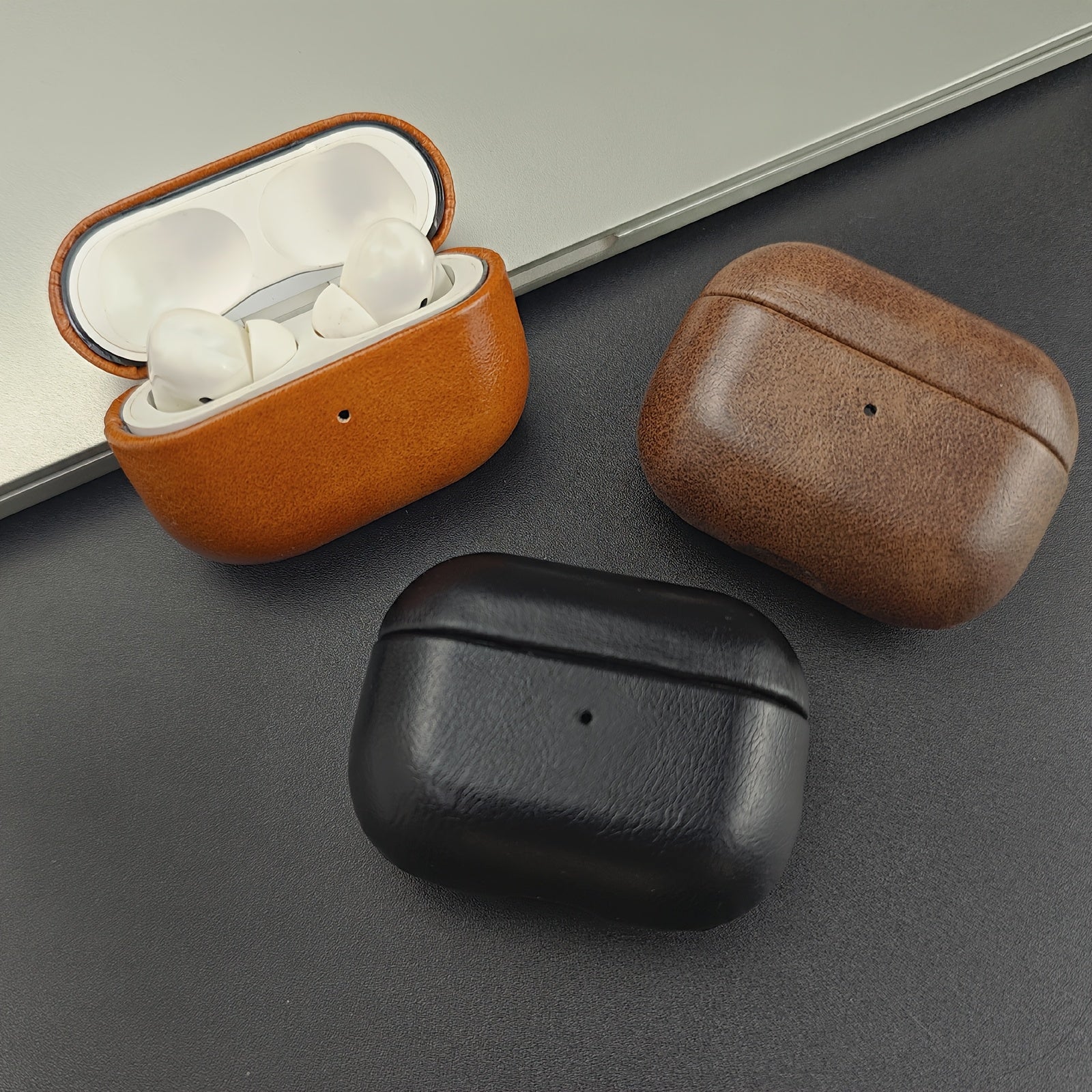 Durable full-grain leather earbud case with drop protection. Premium tech accessory for wireless charging.