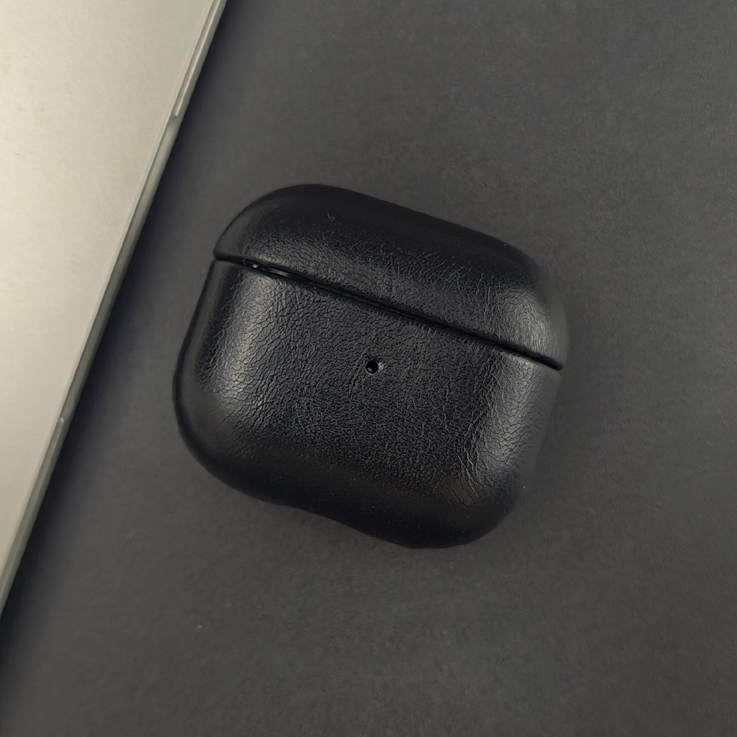 Elegant full-grain leather earphone accessory. Slim protective case for earbuds with wireless charging support.