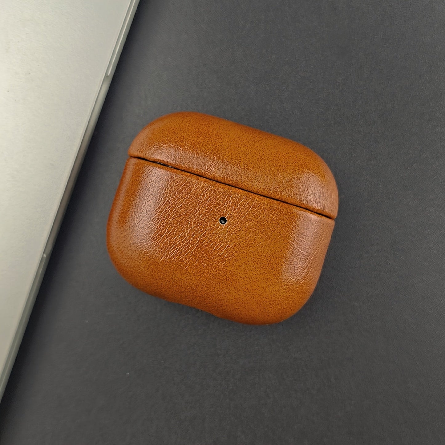 Scratch-resistant leather earbud case with drop protection. Premium quality slim design for wireless earbuds.