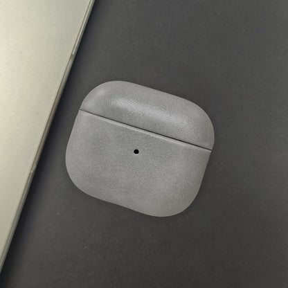 Full-grain leather earbud charger case. Premium, slim, and protective tech accessory supporting wireless charging.