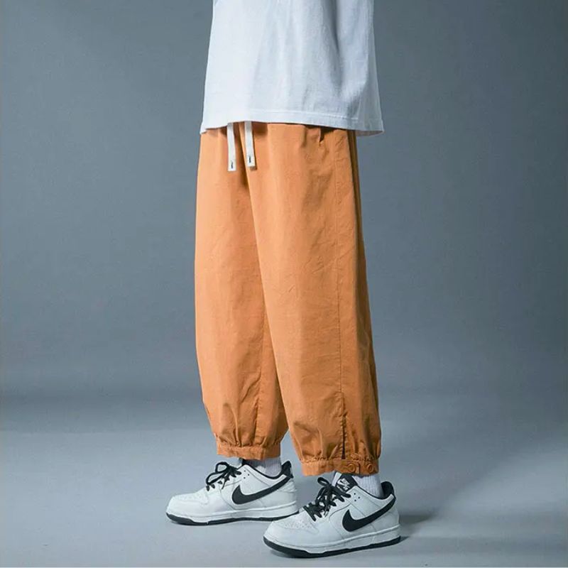 Comfortable unisex lounge pants with drawstring waist & relaxed fit, perfect for athleisure & casual wear.