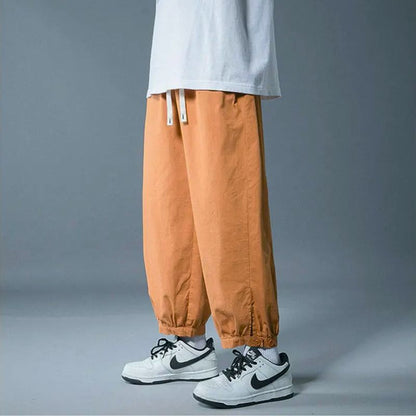 Comfortable unisex lounge pants with drawstring waist & relaxed fit, perfect for athleisure & casual wear.