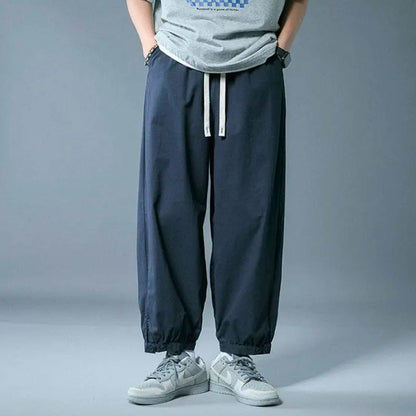 Versatile unisex casual pants with drawstring & relaxed fit, great as bottoms for comfortable daily use.