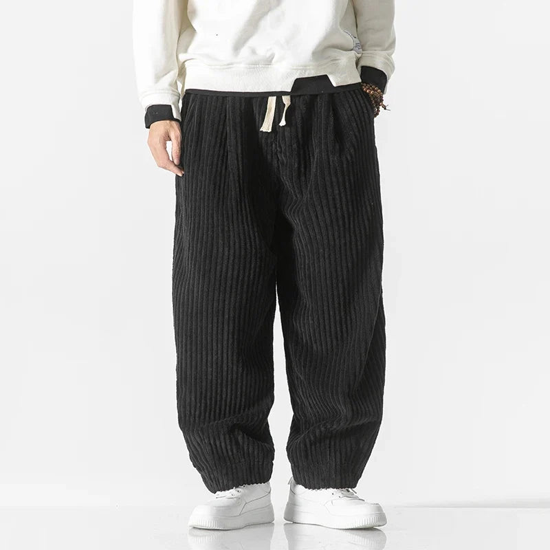 Black unisex relaxed fit pants, a sleek and comfortable option for stylish everyday wear.