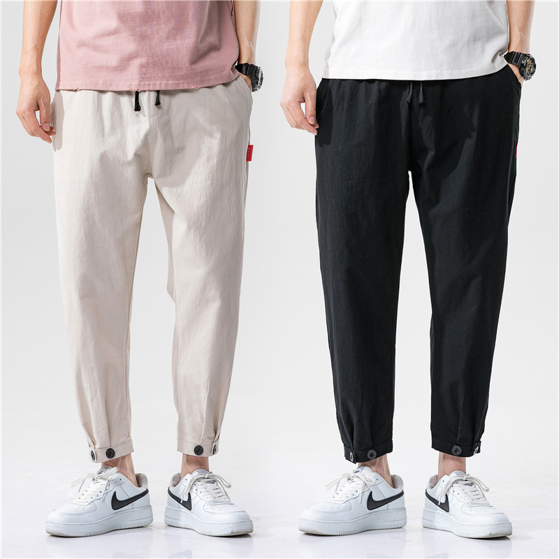 Breathable linen blend relaxed fit drawstring trousers, unisex style for comfortable summer bottoms with adjustable cuffs.