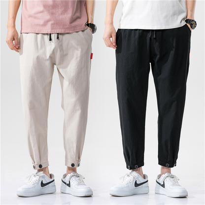 Breathable linen blend relaxed fit drawstring trousers, unisex style for comfortable summer bottoms with adjustable cuffs.