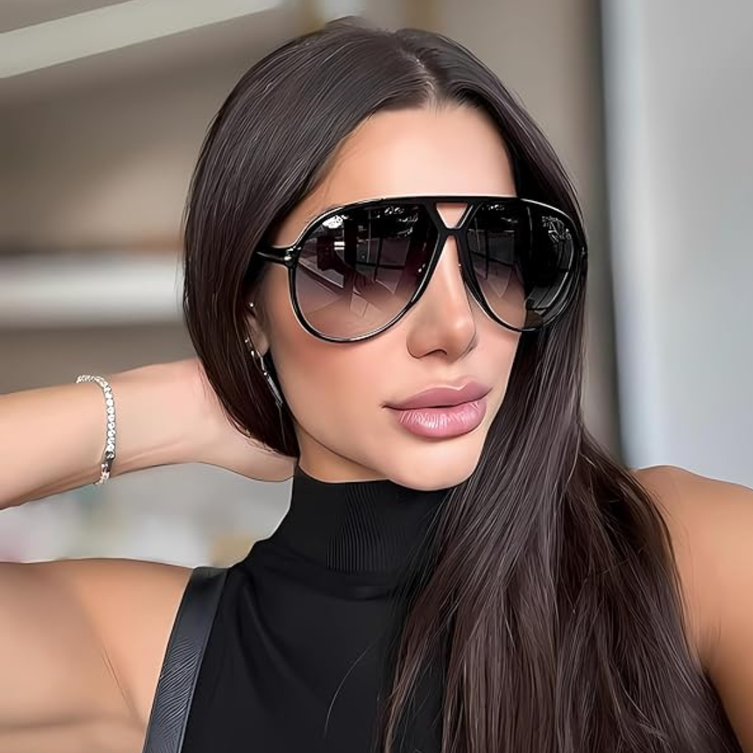 Woman modeling stylish retro oversized aviator sunglasses, showcasing vintage fashion.