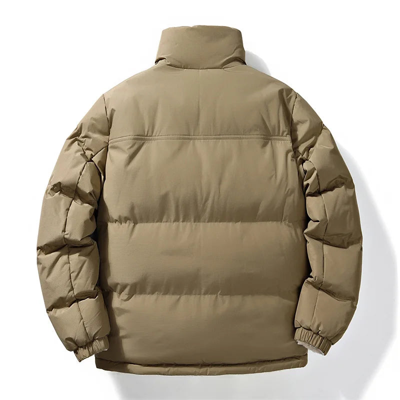 Man wearing a versatile unisex reversible winter jacket. Stylish quilted outerwear for cold weather.