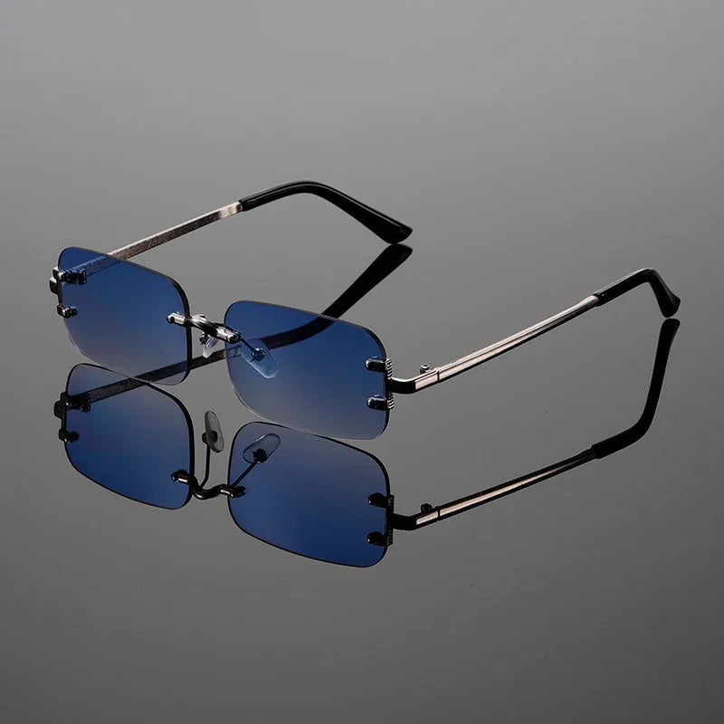 Anti-glare rimless rectangular sunglasses, unisex design. Provides eye protection with sleek metal frame.