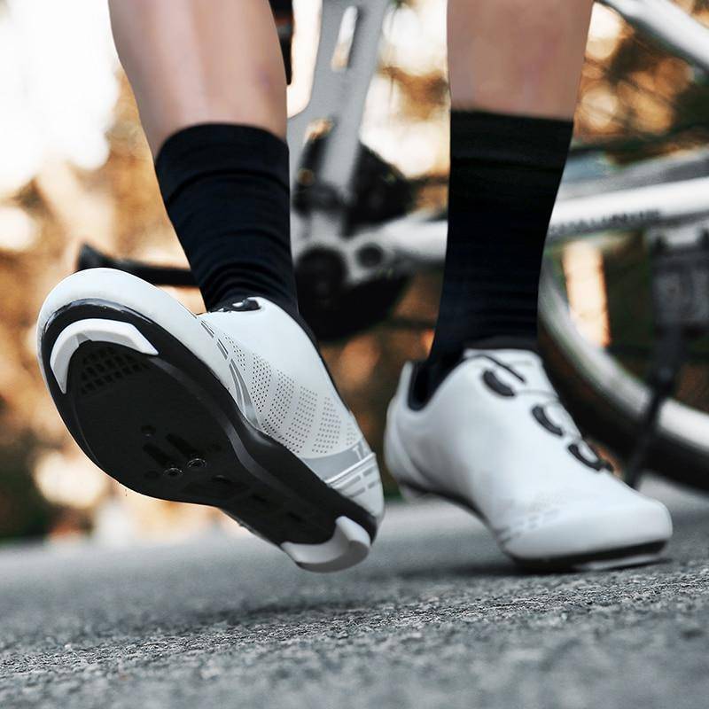 Close-up of black unisex road cycling SPD SL shoes, showing lace lock system and outsole