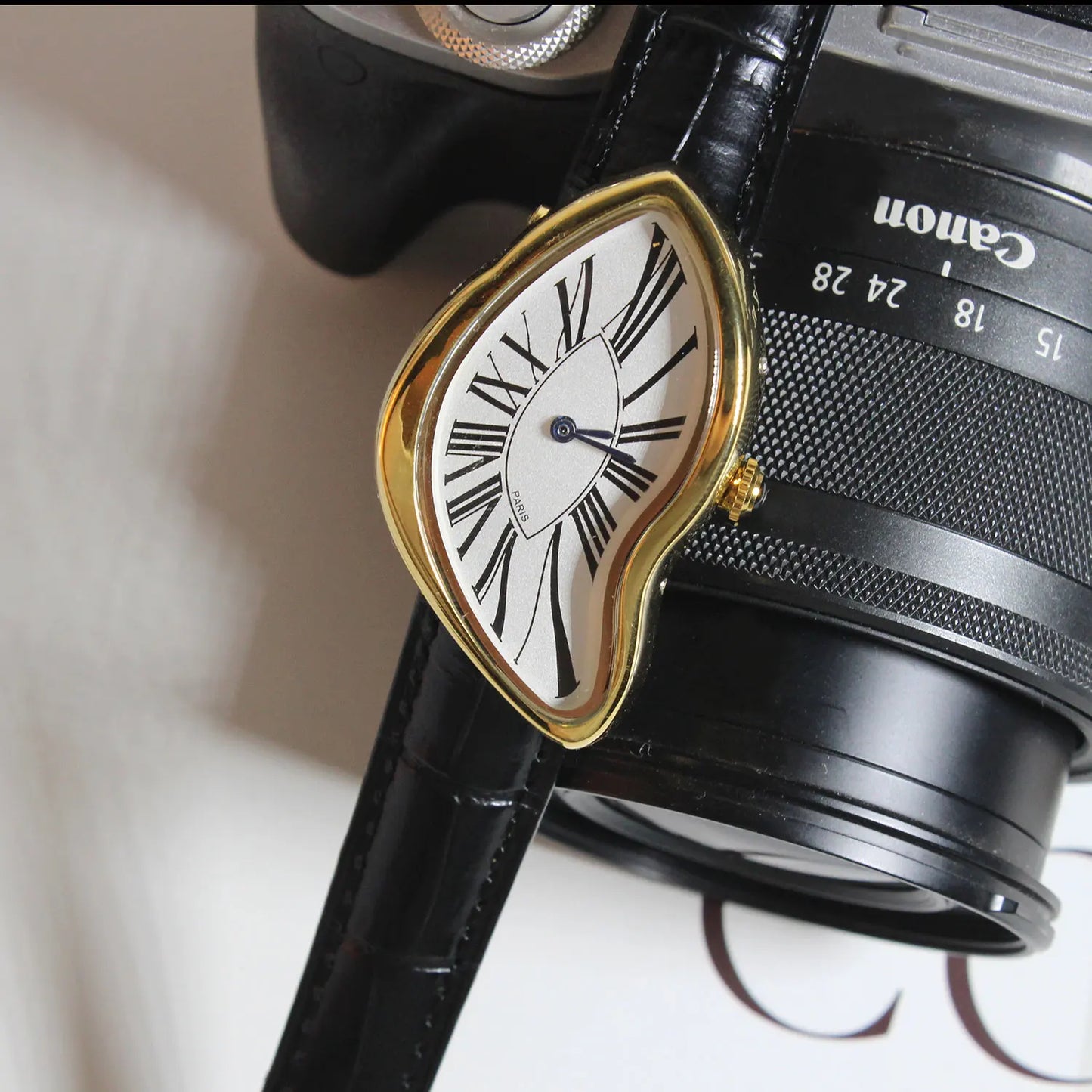 Stylish unisex watch for men & women, showcasing an asymmetric sculptural design with a classic leather strap.