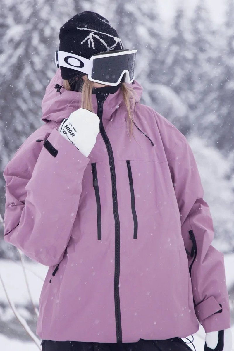 Close-up of durable fabric & waterproof zippers on a unisex ski & snowboard jacket for cold weather.