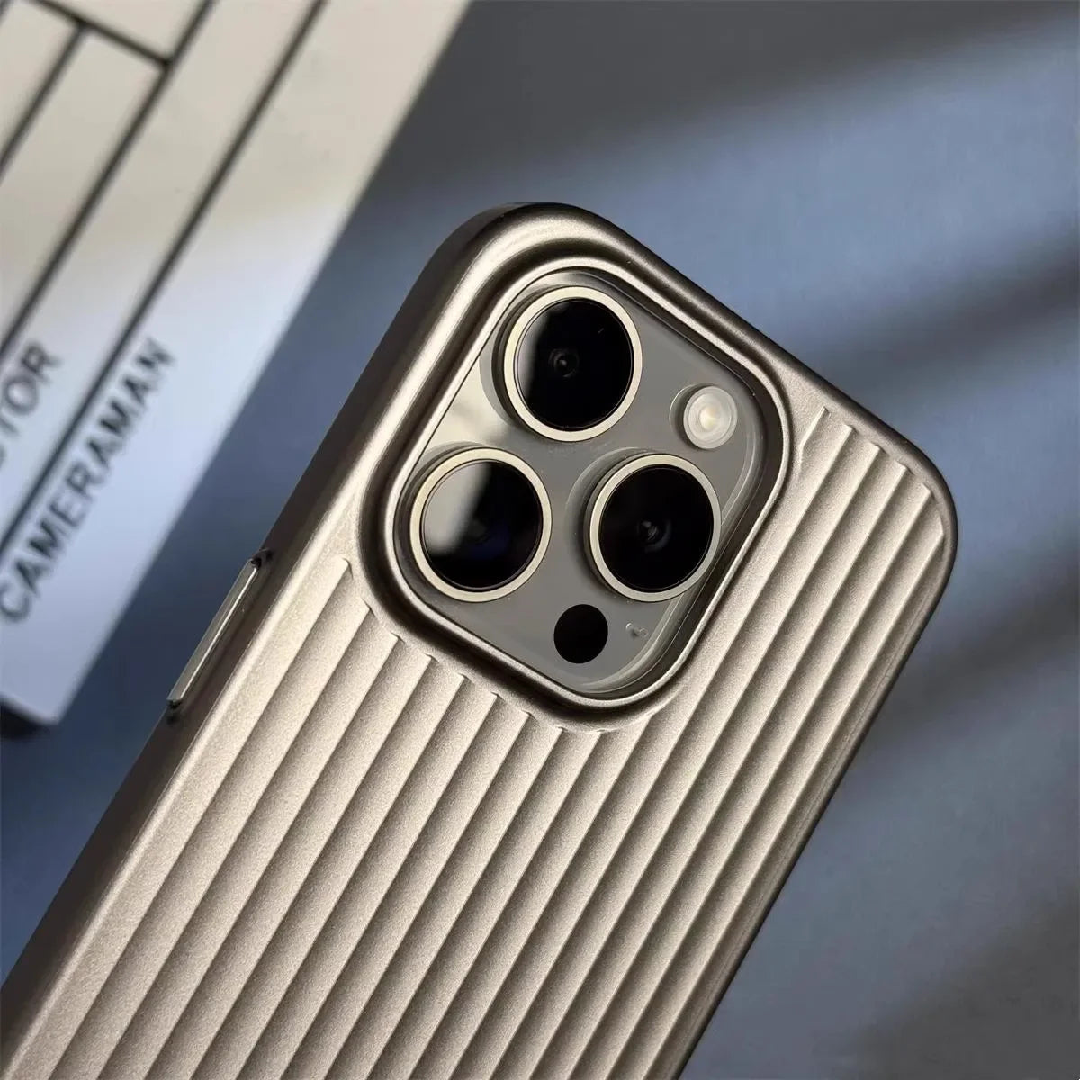 Slim titanium iPhone case with secure grip, supporting wireless charging. Essential phone accessory.