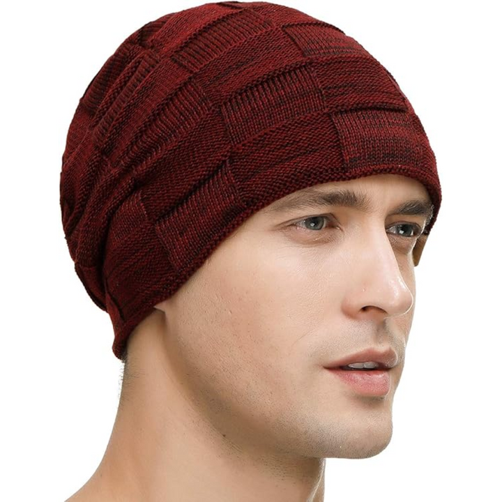 A comfortable knitted slouchy beanie, providing unisex warmth and a fashionable look for cold winter days.