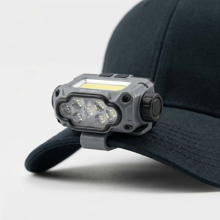 USB rechargeable LED clip light attaches to hats for hands-free illumination during camping, fishing, and hiking.
