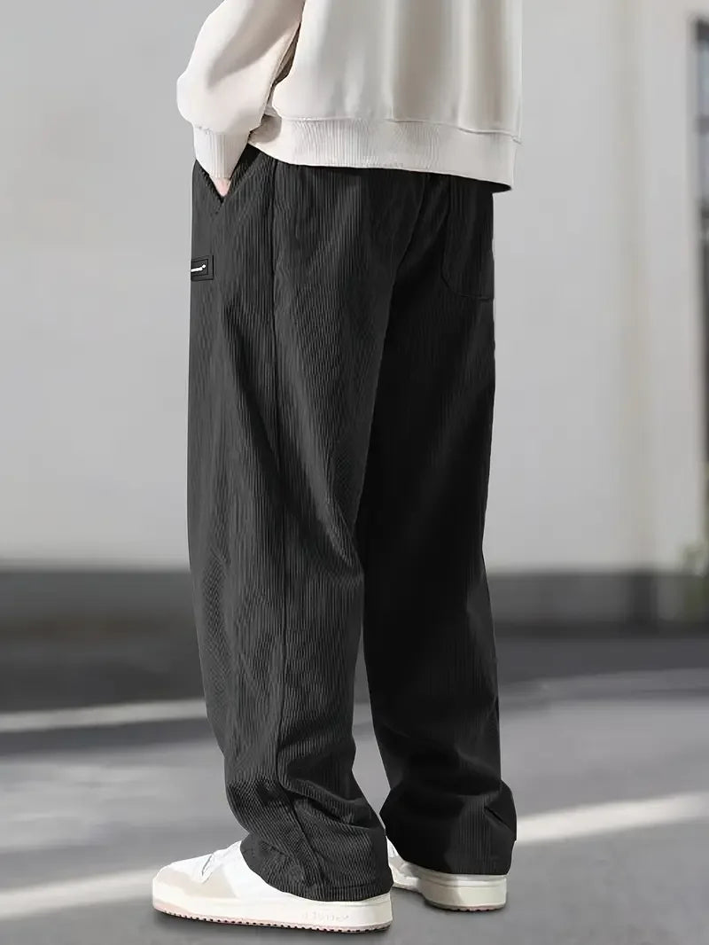 Unisex wide leg corduroy pants with an adjustable drawstring waist, ideal for a casual fit.