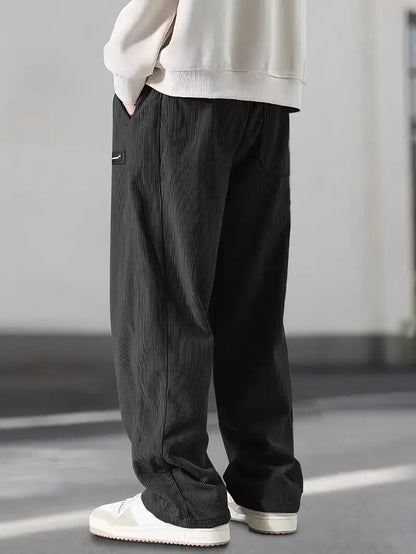 Unisex wide leg corduroy pants with an adjustable drawstring waist, ideal for a casual fit.