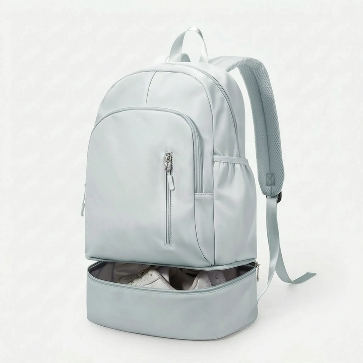 Sleek black sports backpack for men & women, featuring a dedicated bottom shoe compartment and ample storage.