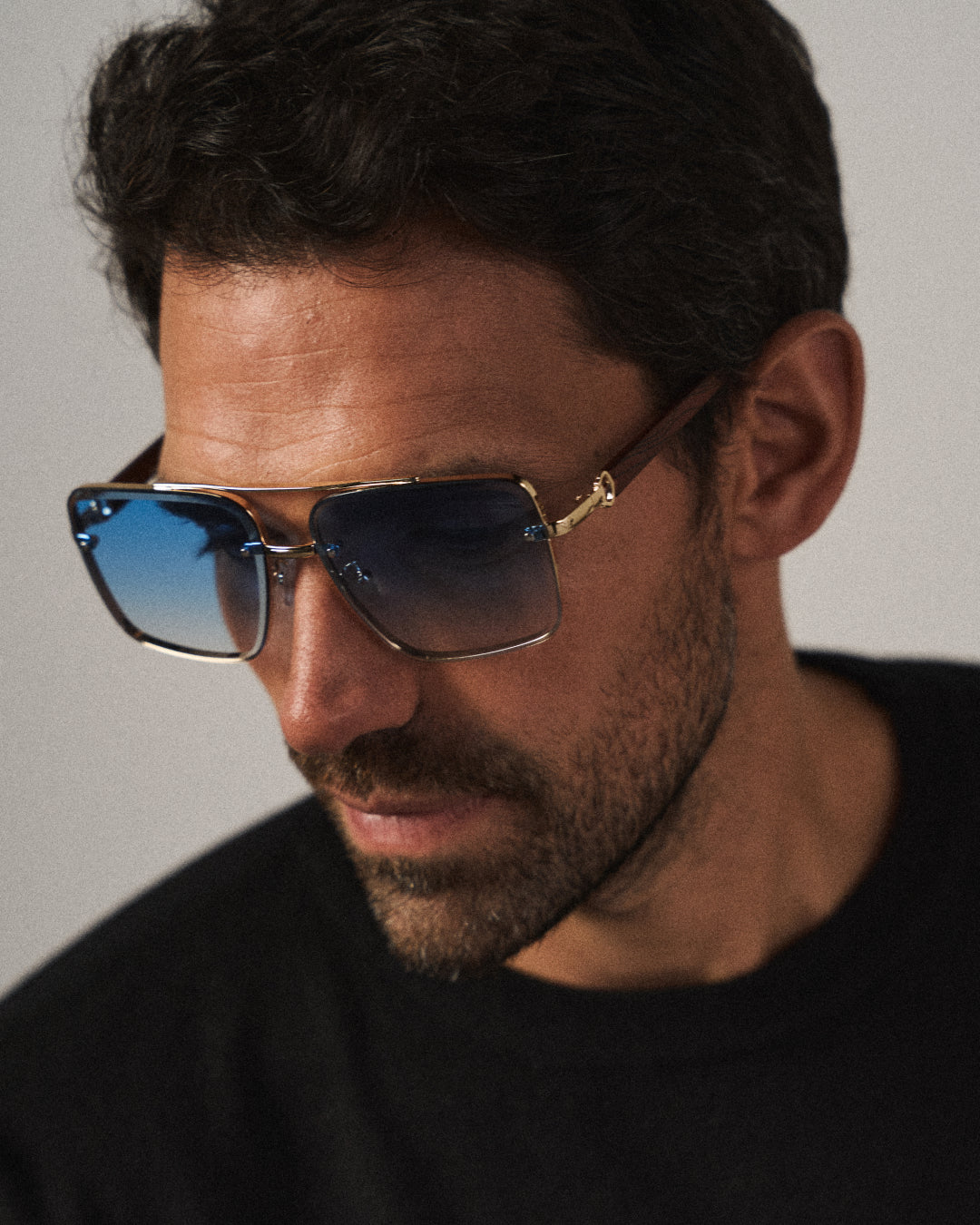 Sleek square metal frame sunglasses featuring natural wood arms, ideal unisex eyewear.