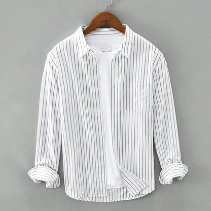 Unisex striped button-up shirt in light fabric, perfect for warm weather and casual summer styling.