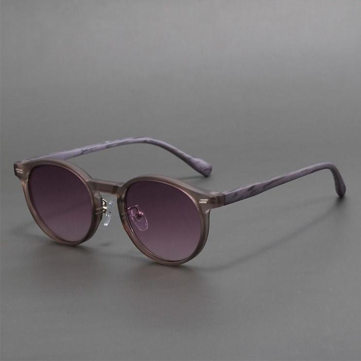 Purple round lenses in stylish unisex sunglasses. Trendy eyewear offers essential UV protection.