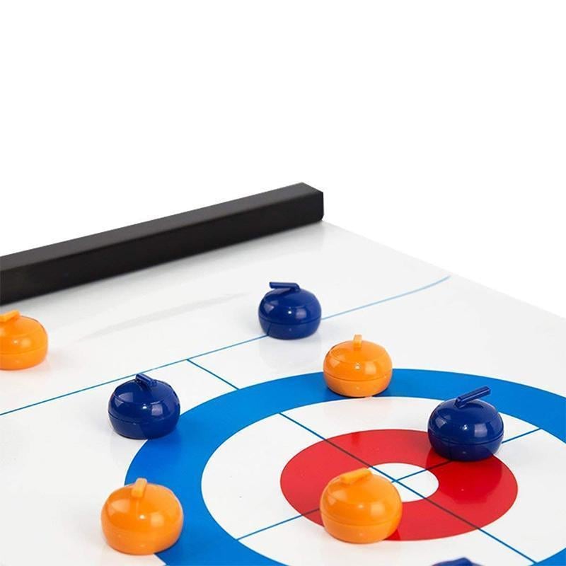 Hands setting up the Tabletop Curling board game, preparing for a festive indoor activity.