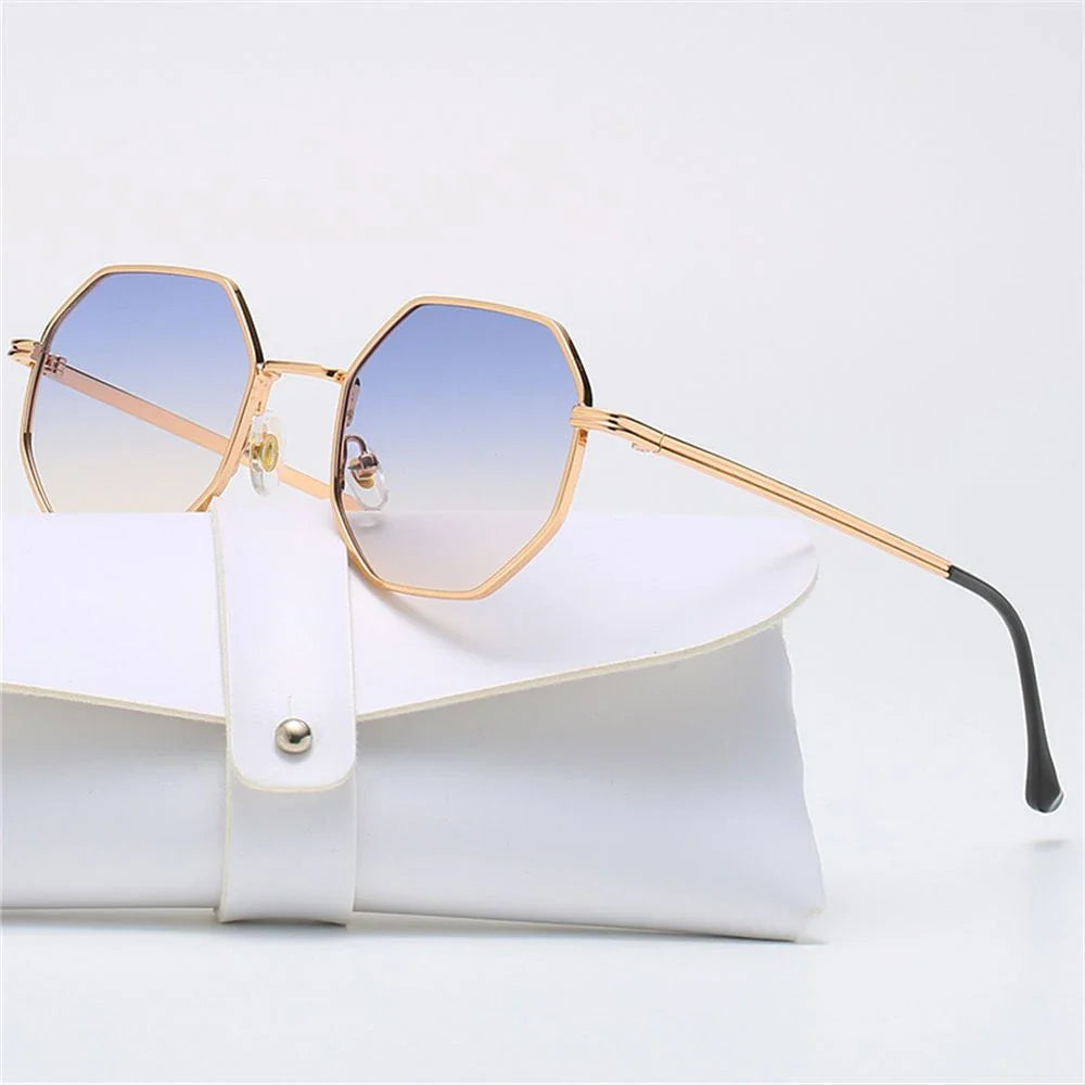 Modern unisex eyewear, gold frame tetragon shades, blue lenses.