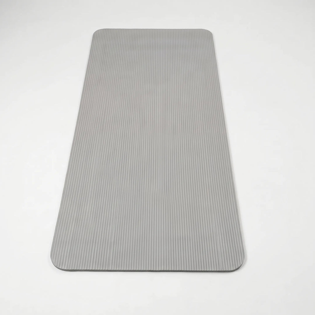 Durable workout mat for high-impact exercise, providing joint cushioning & stability for home gym use.