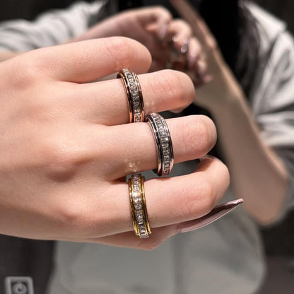 Fashionable unisex titanium steel spinner ring with CZ, a discreet fidget for anxiety relief.