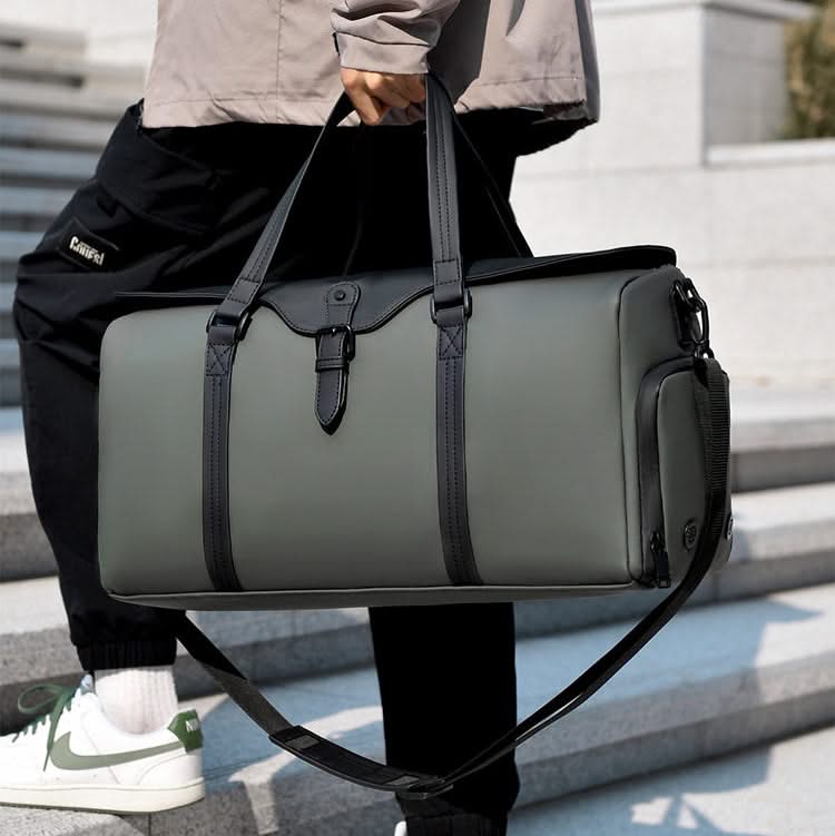 Spacious black duffle bag for weekend getaways, carry-on size with an adjustable shoulder strap.