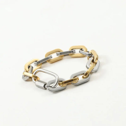 Unisex two-tone chunky carabiner bracelet made from gold-plated stainless steel, a bold fashion accessory.