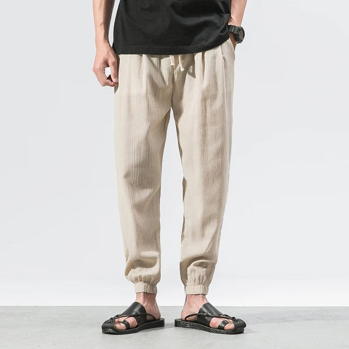 Model wearing comfortable, relaxed fit unisex joggers, showcasing deep pockets and soft cotton blend.
