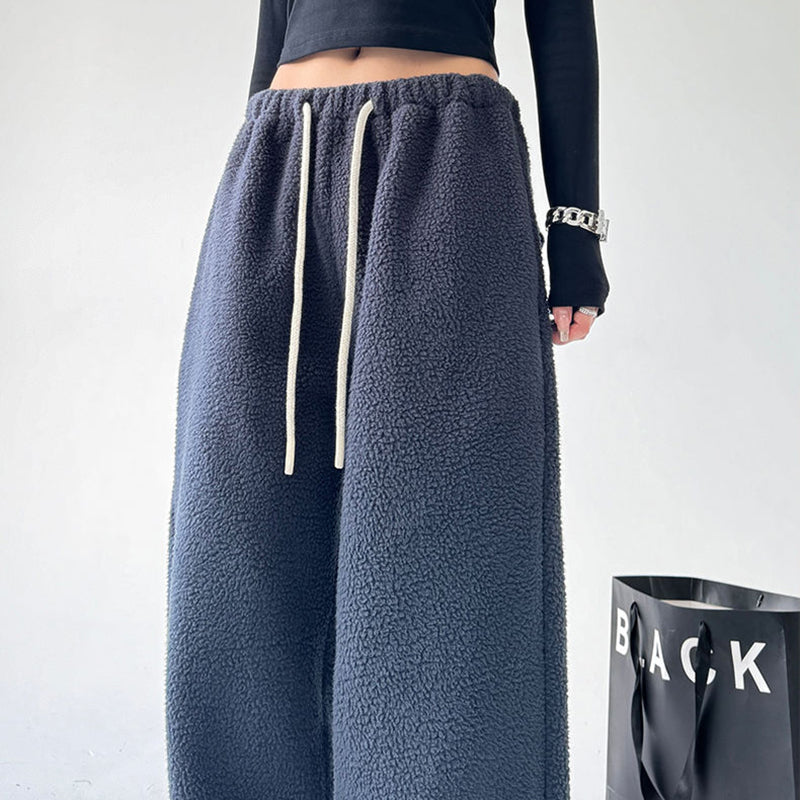 Adjustable drawstring waist on ultra-soft unisex joggers, ensuring a perfect, comfortable fit for relaxing at home.